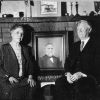 Oscar and Nellie Beuchel with a photo of Jonah R. Lewis