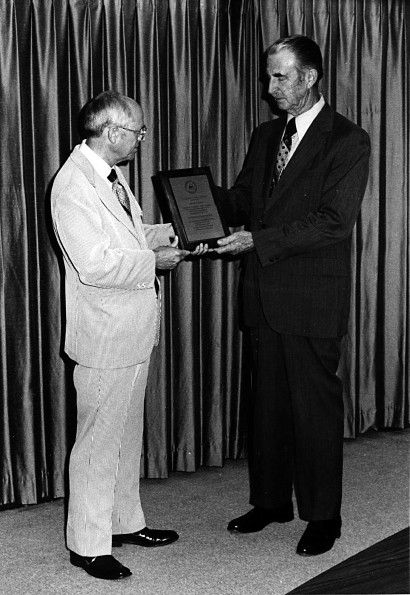 Edward C. Banks receiving an honorary plaque from Richard Hammill
