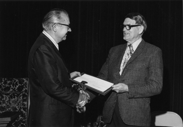 Lawrence E. Smart is presented with an award in recognition of the 36 years of service to Seventh-day Adventist education
