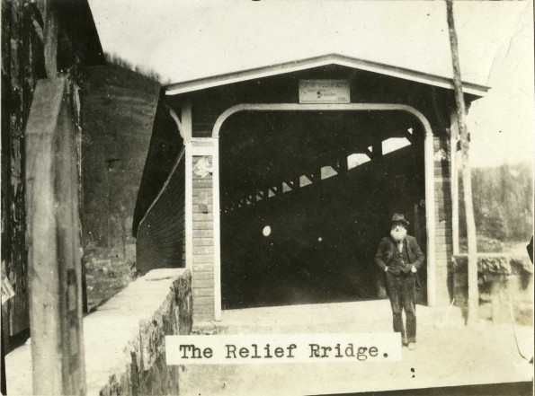 Stockbridge Howland standing in front of the Relief Bridge that he constructed