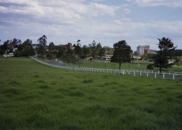 Avondale College showing entrance road and college buildings and Sanitarium Foods factory in the distance, 1995