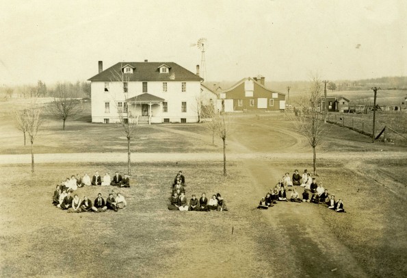 Cedar Lake Academy general campus view with a dormitory and farm buildings, 1916-1917