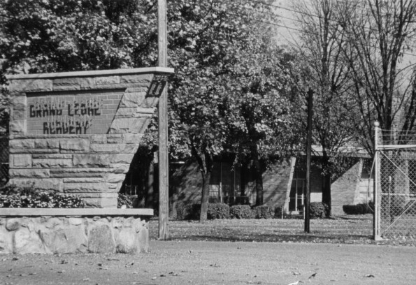 Grand Ledge Academy sign with school, 1970s