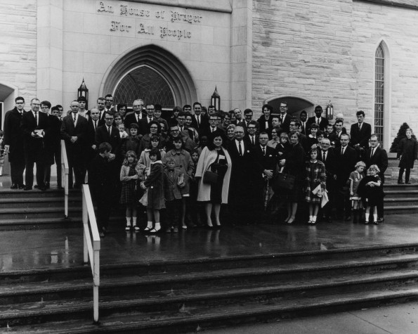 Group of people on the steps of the Pioneer Memorial Seventh-day Adventist Church who are planning to begin the Stevensville Seventh-day Adventist Church the following Sabbath