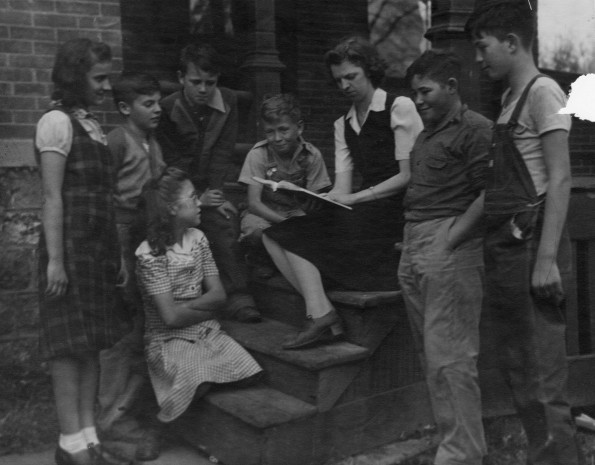 Students and their teacher listen to a story at the St. Johns Seventh-day Adventist Church (Mich.)