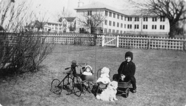A young Margaret Tucker with her toys and dog