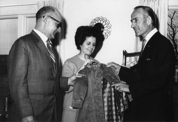 Congressman Jerry Pettis, Mrs. John Kronke, and Mayor Edgar Kesterke examine a coat made from leftover fabric at the Berrien Springs Community Services Center (Mich.)