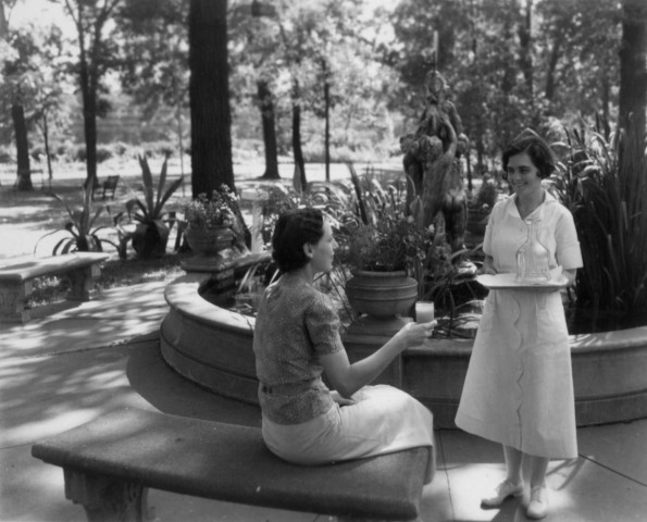 Hinsdale Sanitarium and Hospital patient receiving a drink while enjoying the grounds