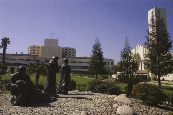 Loma Linda University Good Samaritan sculpture with the University Church and the Medical Center after the addition of the Chan Shun and Coleman pavilions