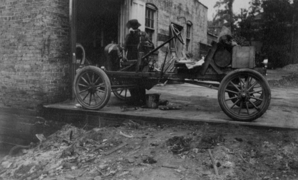 Automobile chassie from 1920's eara outside a repair shop