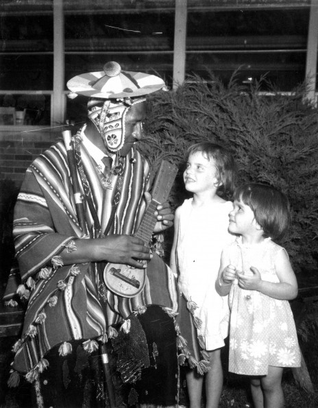 South American native serenades two small unknown western missionary children