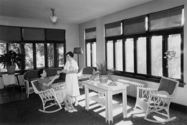 Hinsdale Sanitarium and Hospital patient receiving a drink while enjoying a sun room