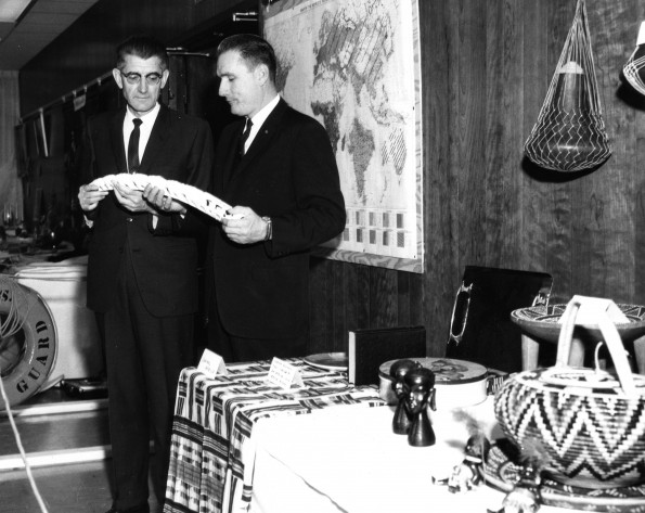 Myrl Manley and David Baasch examine a carved ivory tusk from Africa as part of the World Mission Exhibit at Andrews University Feb. 21 thru Mar. 1, 1967
