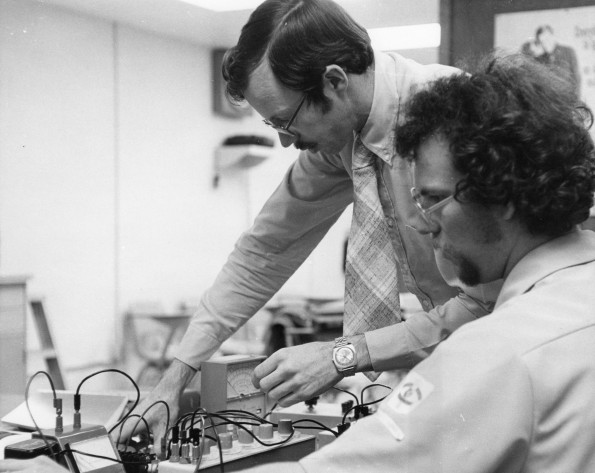Walla Walla College teacher helps a student in electronics lab