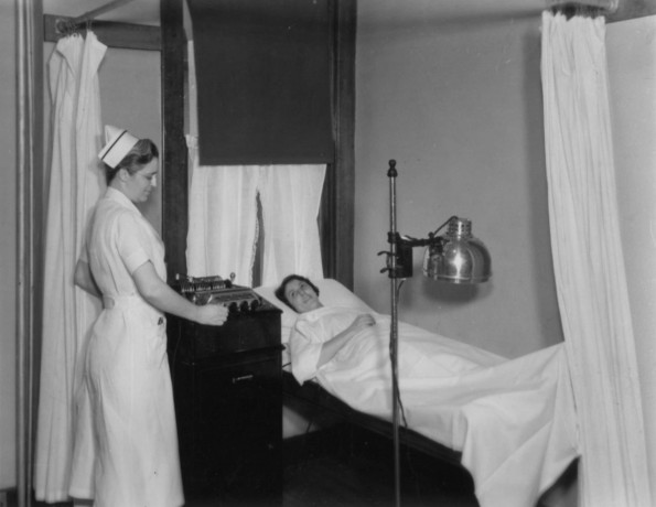 Hinsdale Sanitarium and Hospital patient getting ready for a treatment from her nurse