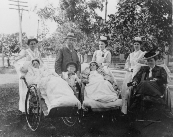 Battle Creek Sanitarium patients in wheelchairs outdoors with their attendants