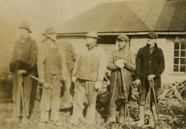 Unknown workmen with tools in hand