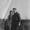 Man and lady pose together on the roof of a building