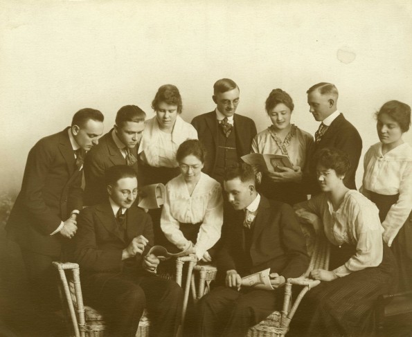 Professor Paul T. Gibbs and a group of Union College students look at College publication, 1919