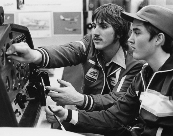 Andrews University flight instructor teaching student how to use a plane control panel