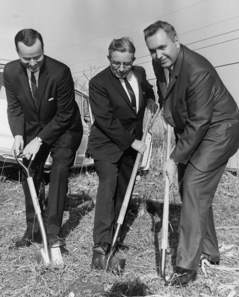 Three men at a breaking ground event for Andrews University aviation building construction