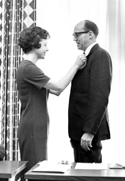 Andrews University board of trustees 1966-1967 member pinning on a boutonniere