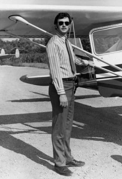 Andrews University flying student missionary Dan Wenberg in front of a plane