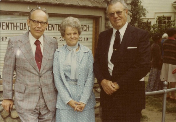 [Glenn Bowes, Dorothy Bowes, and Tom O. Willey at a Sabbath harvest ingathering service]