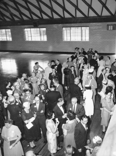 Andrews University alumni mingle and talk prior to the Homecoming banquet in Johnson Gymnasium, 1960