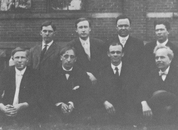 E. J. Waggoner with workers in England