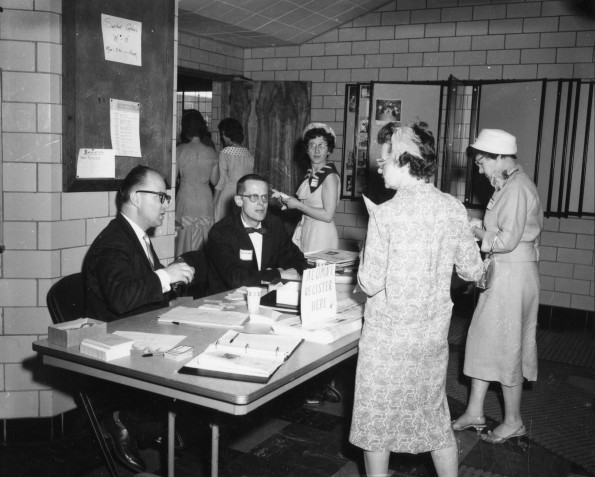 Andrews University alumni register in Johnson Gymnasium lobby during Homecoming 1960