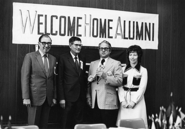 [Wilson L. Trickett yields the office of Alumni Association president to Floyd Costerisan at Andrews University's 1973 homecoming]