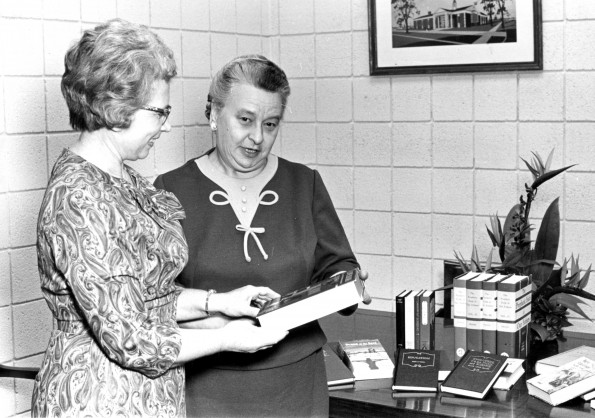 [Mary Jane Mitchell, librarian of the James White Library, giving 22 books to Mayme Bachteal, librarian at the St. Joseph Public Library]