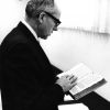 [Wilber Alexander examining a 1553 Tyndale Bible in the Andrews University Heritage Room]