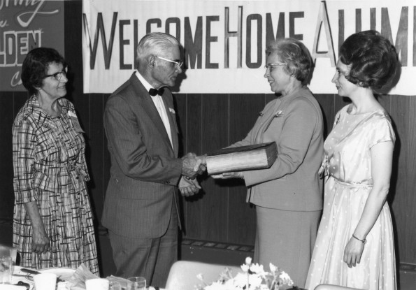 [Mr & Mrs. Bryan Votaw presenting the Heber Votaw Burmese Bible to Mary J. Mitchell and Louise Dederen]