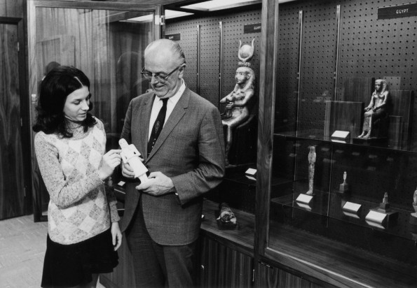 [Siegfried Horn showing Debbie Boyer a figurine in the Andrews University Archaeological Museum]