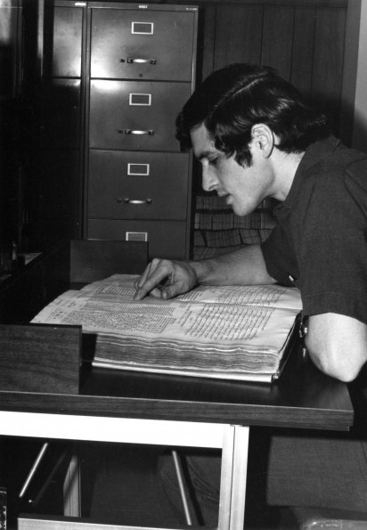 [A student looking at an old multilingual Bible in the Andrews University Heritage Room]