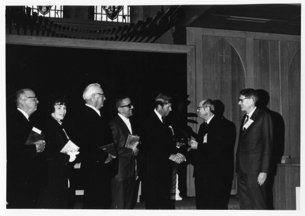 [Richard Hammill and Wilson Trickett congratulating distinguished alumni]