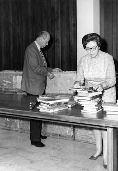 [Richard Powell and Olivia Harder unpacking books for the annual display at the James White Library]