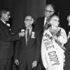 [C. N. Keiser and Hallie Taylor as representatives of the class of 1912 receive flowers during Andrews University's 1972 alumni homecoming}