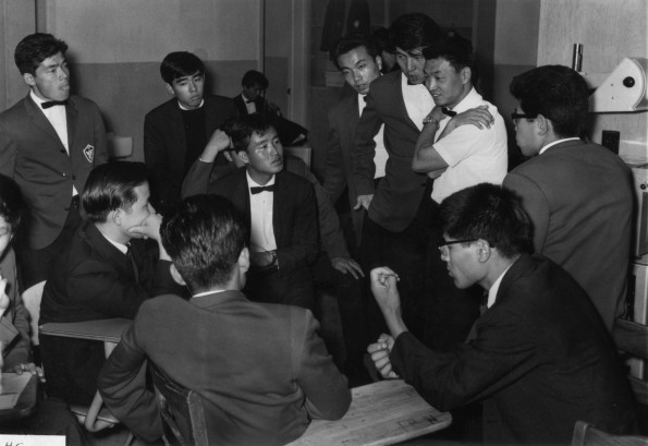 Male members of Japan Missionary College Choral Arts Society talking among themselves