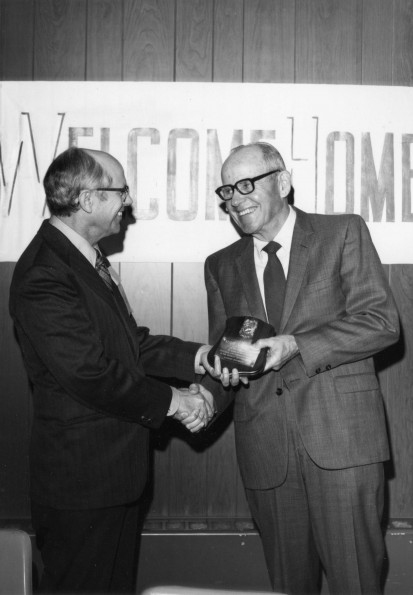[Wesley Christiansen accepting a plaque from Richard Hammill during Andrews University's 1972 alumni homecoming]