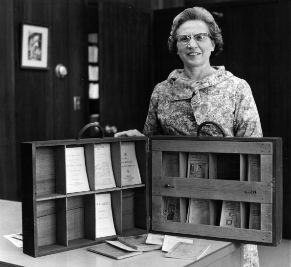 [Mary Jane Mitchell standing with John Andrews' Literature Case that was donated to the James White Library]