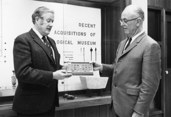 [Robert Little giving some coins to Siegfried Horn as a donation for the Andrews University Archaeological Museum]