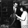 [Martin Ambs and Julie Shull examining a musical instrument from Congo that was recently donated to the James White Library]