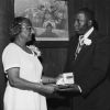 [Natelkka Burrell is presented with an award in recognition of nearly 50 years of service]