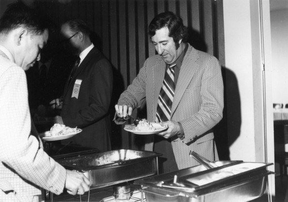 [William Hamberger getting food at the Sunday brunch during Andrews University's 1972 alumni homecoming]