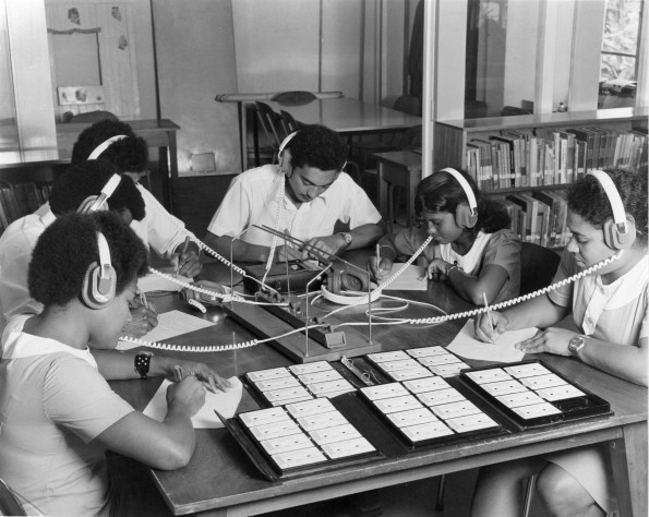 Fulton College students listening to audio cassette material in the school library