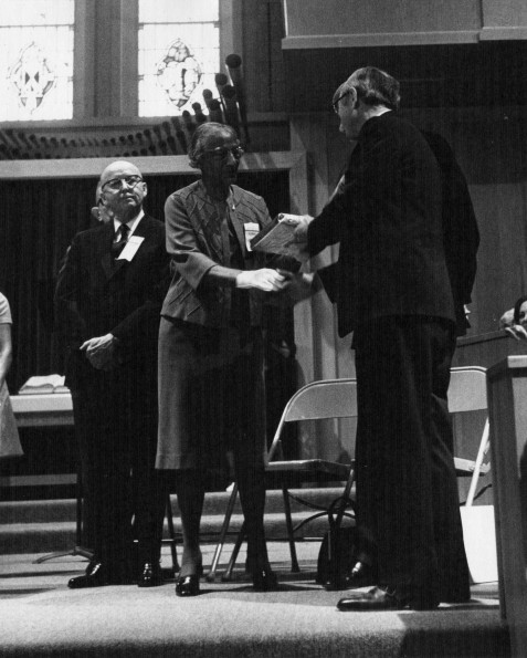 [Natelkka E. Burrell receiving an award from Richard Hammill during Andrews University's 1973 alumni homecoming]