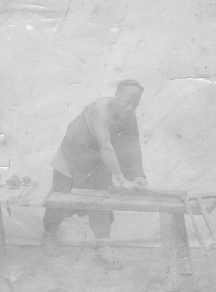 Chinese carpenter shaping wood